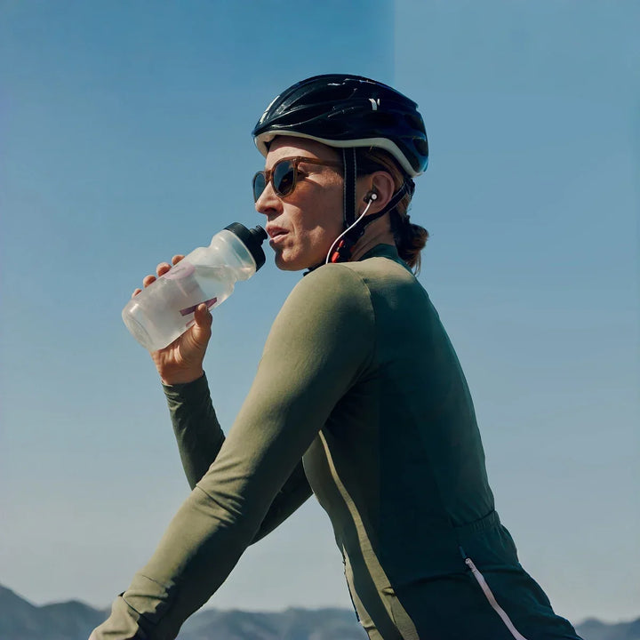 Cyclist taking a hydration break during an outdoor ride.