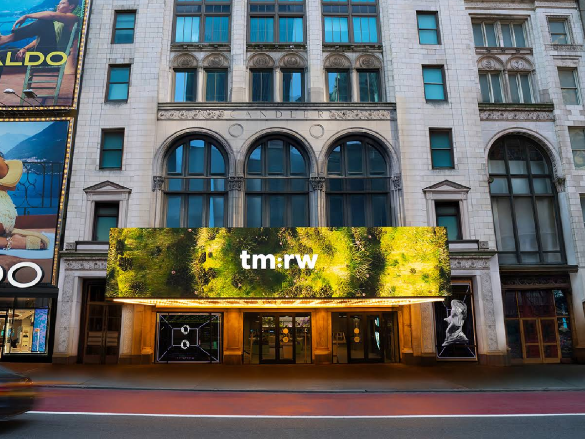 City building with tm:rw billboard, representing wellness for tomorrow