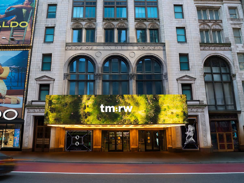 City building with tm:rw billboard, representing wellness for tomorrow